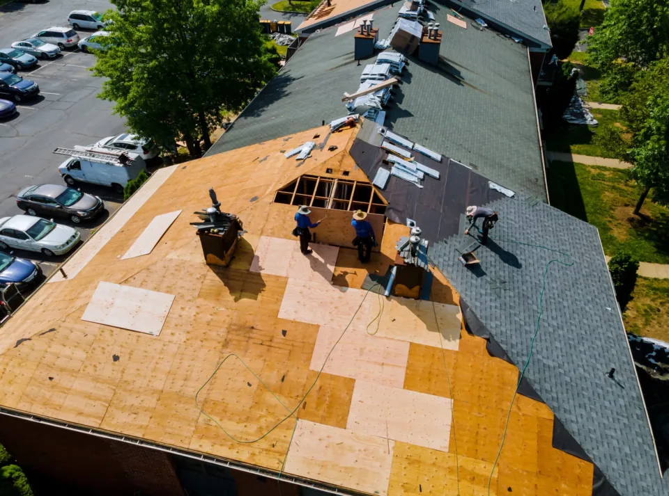Construction worker on renovation roof the house installed new shingles